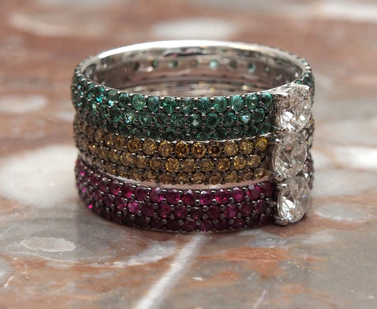 Pave Ruby,Champagne Diamond and Emerald Rings each containing a .22 full cut diamond. Offered as single rings