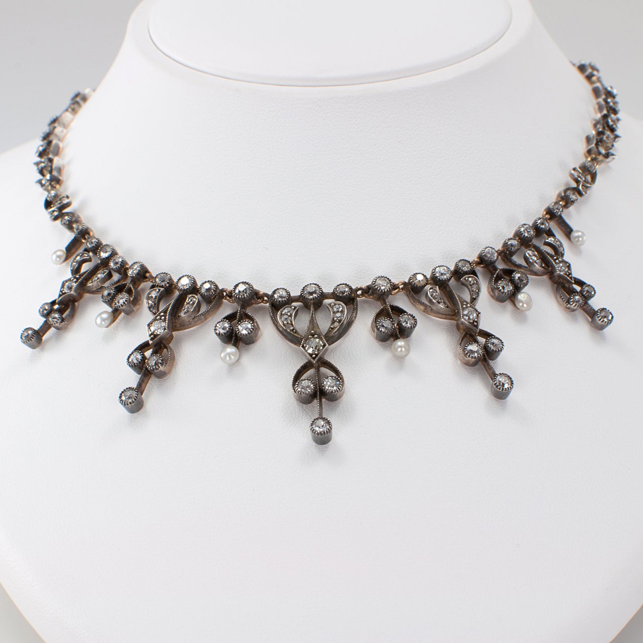 French Victorian Pearl and Diamond Tulip Necklace

Antique pearl and diamond necklace, circa 1890.  True and perfect love, that's what tulips represented in Victorian times.  The dreamy design features a series of graduating scrolling motifs set