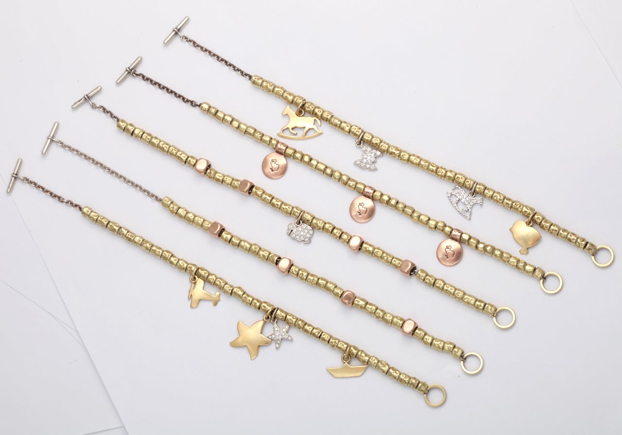 Such a great estate purchase from the DODo collection! The estate features 4 diamond charms (starfish, Dodo, butterfly, and a rocking horse), 4 gold charms (rocking horse, plane, chick, boat) 1 large starfish, 176 gold nuggets, 3 rose gold circle