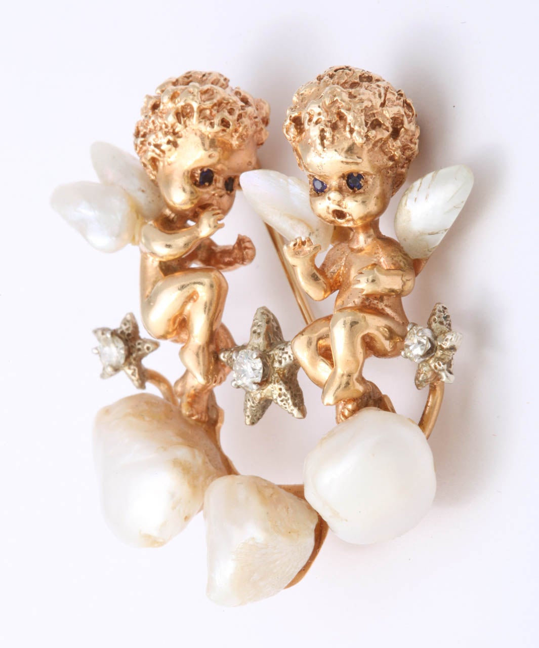 Pair of 14kt Yellow Gold Cherubs with Mississippi Mud Pearl Wings floating on a Pearl Cloud amongst white gold & Diamond Stars.  Signed Ruser in script.
