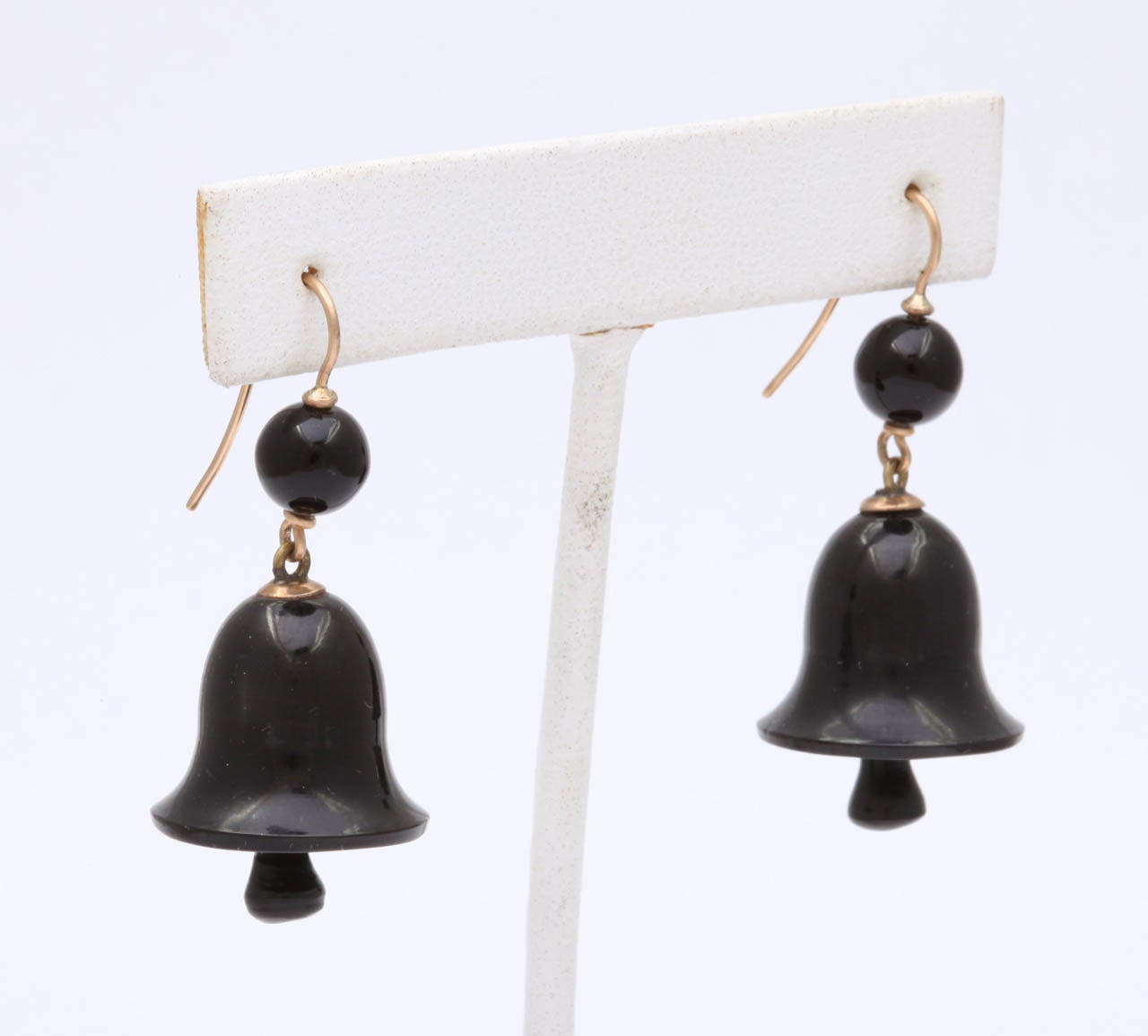 The form and condition of these Victorian earrings is perfect from top orb to clamper below. Smooth shining bells, the symbol of friendship and peace are made from Jet from the city of Whitby England. They will move as you do but will not put weight