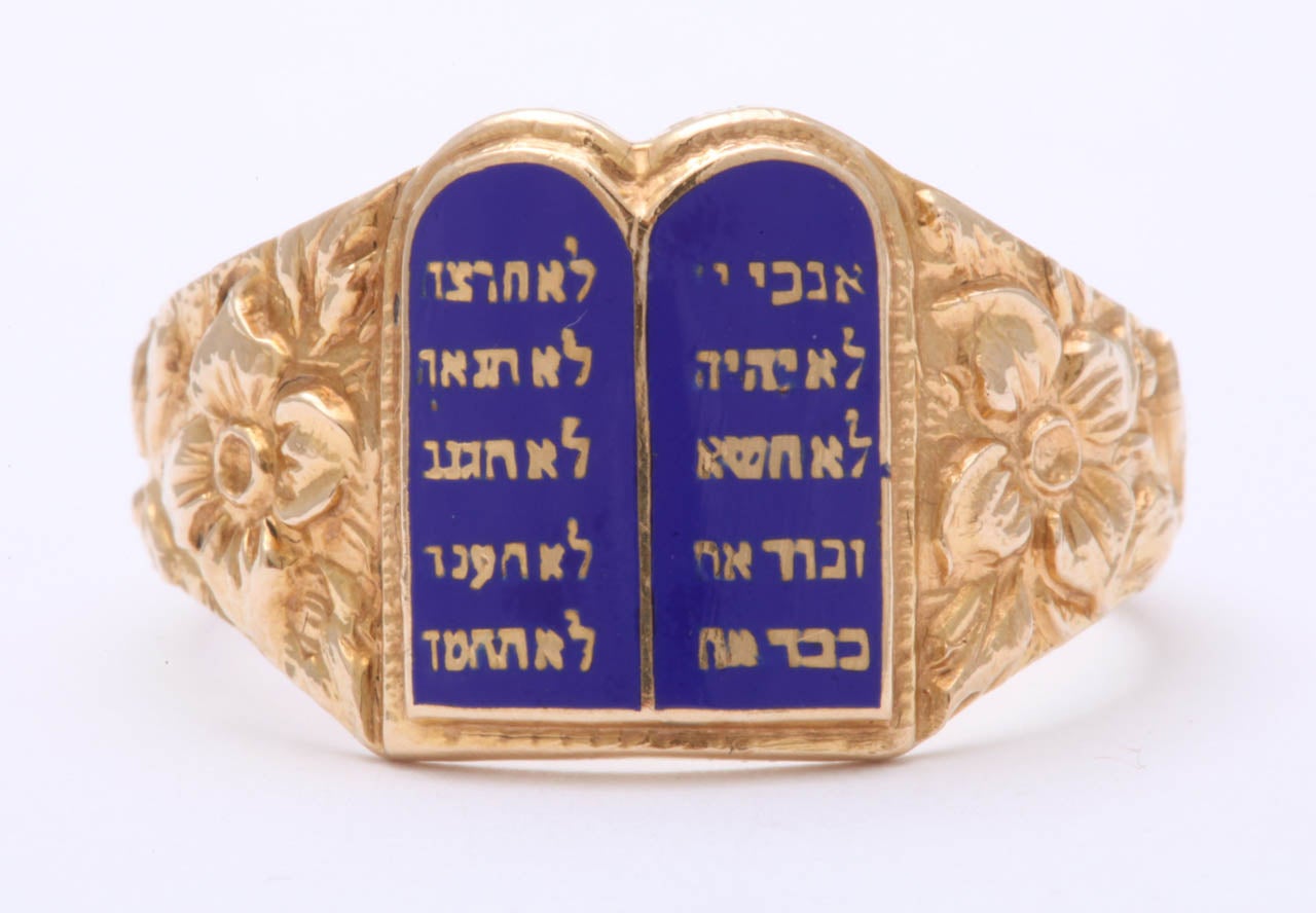 This is a ring that is handsome on a man, beautiful on a lady. Deep repose engraving shoulder an open torah displaying the Ten Commandments in Hebrew. Gold and lustrous navy are the colors. The ring has weight proportionate to its size and a sturdy