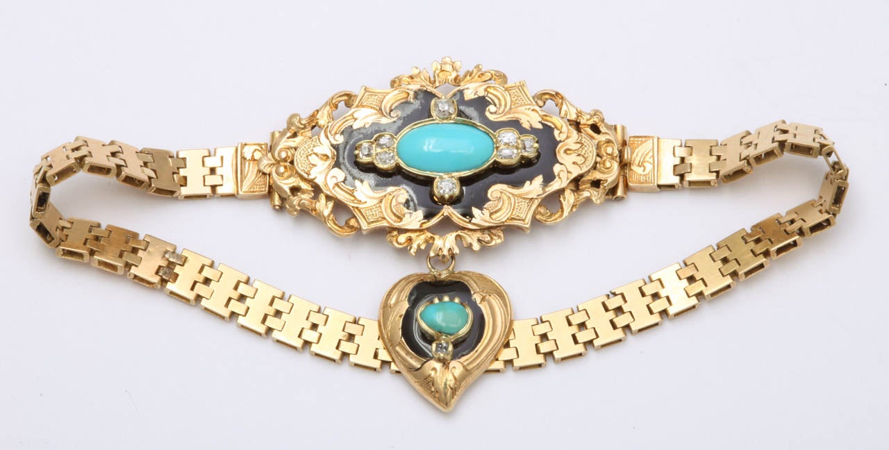 Silky gold links, the type made by fine French goldsmiths, connect with horizontal links that dovetail into one another in this beauty of an 18 karat  gold bracelet circa 1860.  A central medallion will sit atop your wrist.  It is loosely scalloped