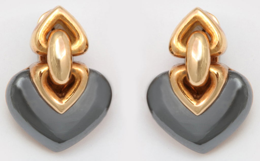 Bulgari Hematite & 18kt Yellow Gold Earrings with Omega Backs & Posts in original Box.  Heart shaped elements connected by a link suspending a Hematite heart shaped element. Signed & marked 750 & Italian control mark.