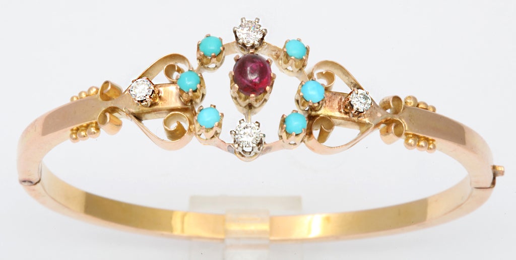 14kt hinged Gold Bangle with prong set Turquoise & Diamond  stones. Center cabochon ruby. Very delicate.