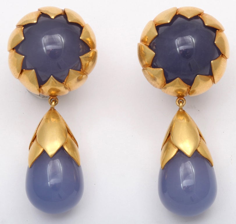 A pair of earrings composed of two cabochon chalcedony beads and two chalcedony drop beads. Each stone is set in an18kt yellow gold petal jacket.