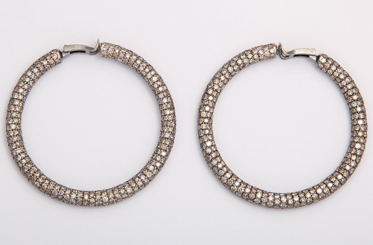 A pair of 18kt white gold and diamond hoop earrings There are approximately 25cts of diamonds.