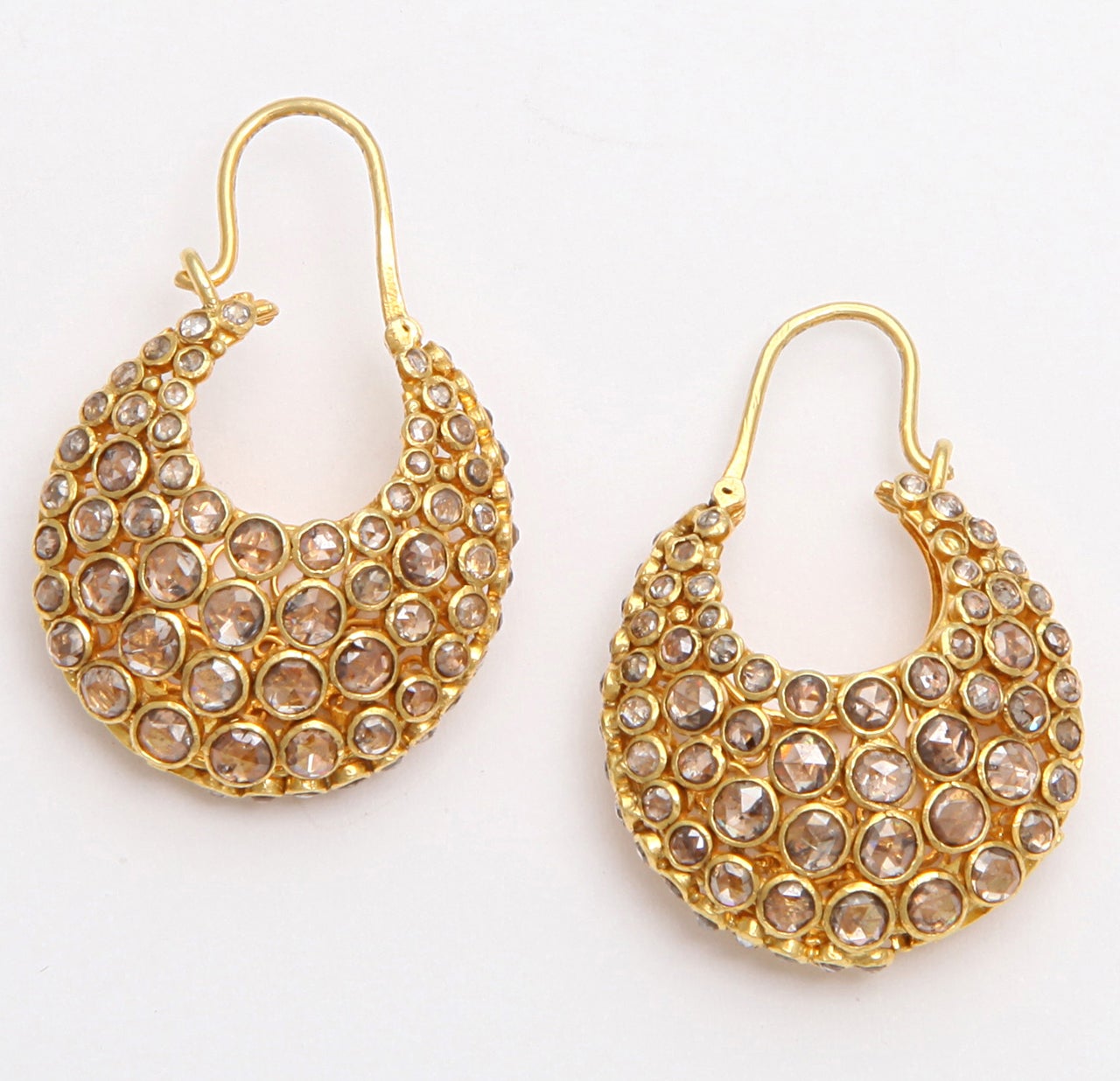 A pair of 18kt yellow gold and diamond earrings. There are approximately 3.21cts of bezel set diamonds