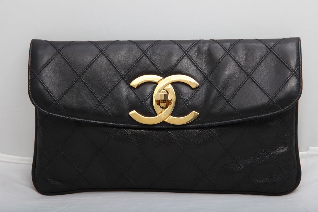 Chanel quilted clutch bag with CC logo closure. Black leather/gold hardware. It comes with an authenticity card, serial sticker.