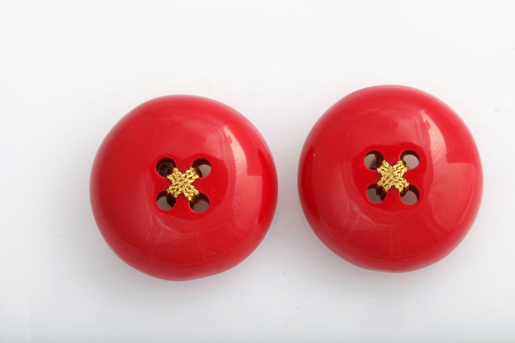 Fanciful giant red button earrings made of a Bakelite type material.