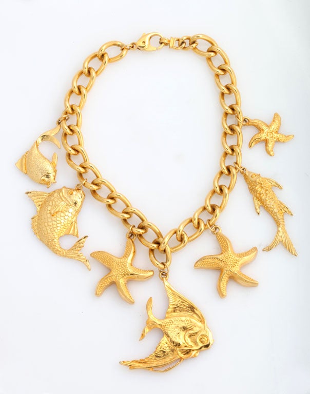 Thick goldtone chain with seven dangling fish.