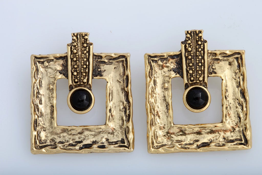 Large chunky goldtone earrings with small black cabochon.