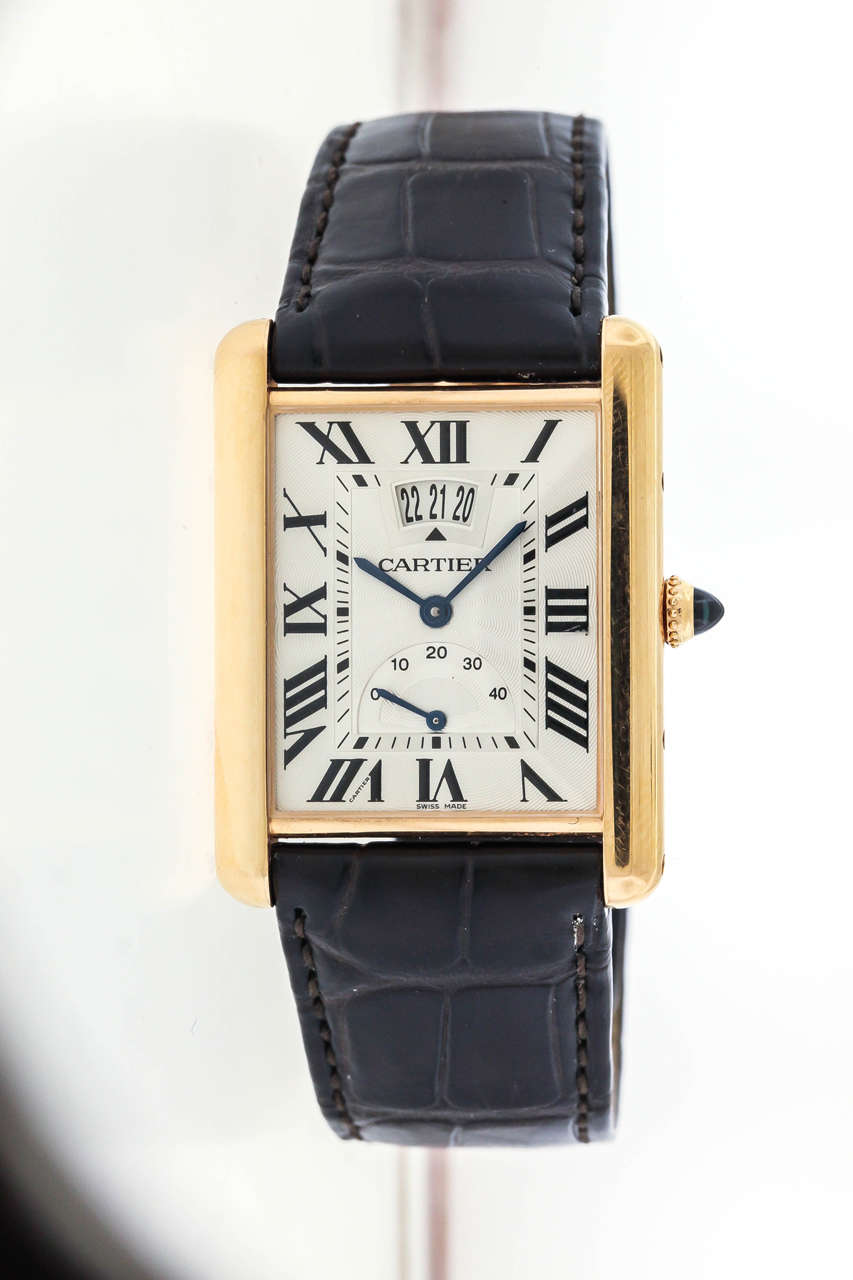 18K pink gold Cartier Ref. 3185 rectangular wristwatch with date and power reserve, circa 2010, is a 30mm x 39mm tank. The guilloche white dial features painted black Roman numeral hours with secret Cartier signature at VII, aperture for the date,