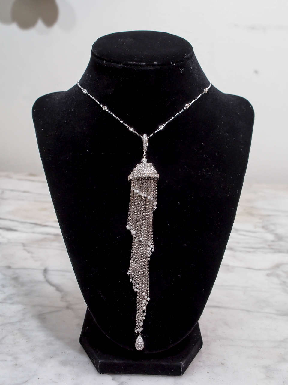 Magnificent Diamond Tassel by Mariani. The top of the  tassel is entirely pavèd with D,E,F colored, VS diamonds. The tassel is made up of chains with diamond beads and a pavè diamond drop on the bottom  There are approximately 19.00cts of diamonds.