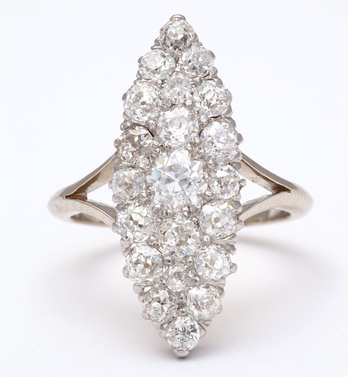 A truly brilliant cluster of white old mine diamonds sets this ring apart from the others of this style,  Set in a marquise shape, the diamonds  are a tribute to the glitter of the Edwardian era. Closely placed in pave form, the stones become a