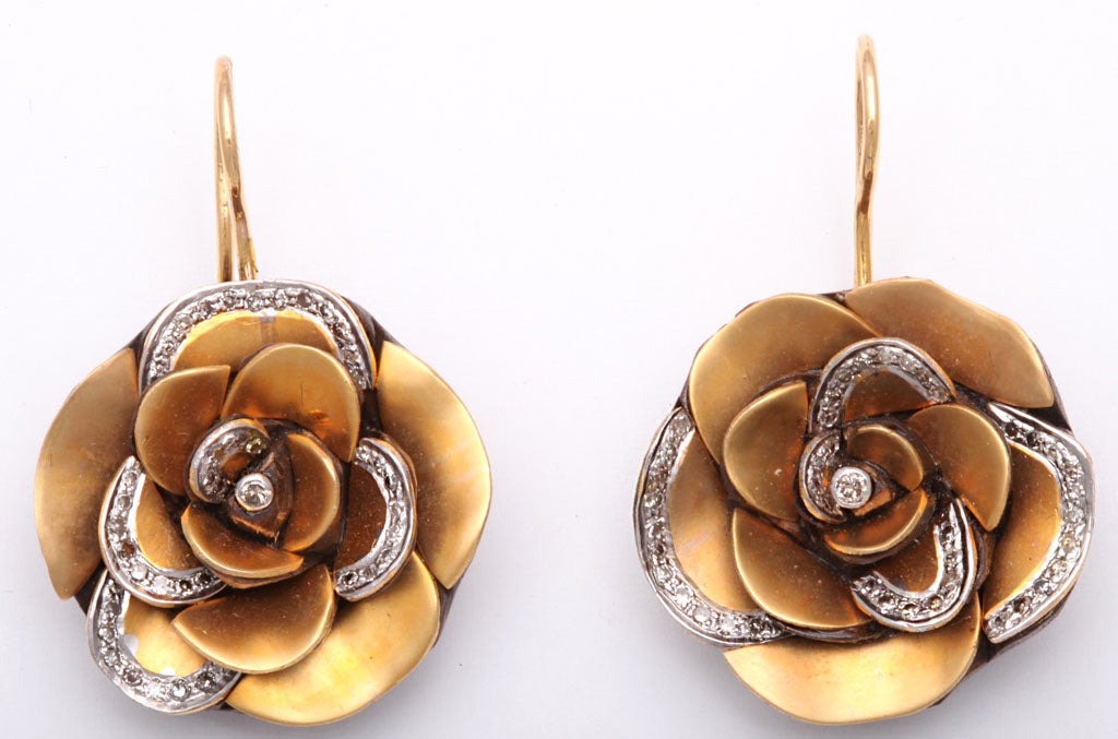 Impressive 3D but light 18k gold flower earrings with diamonds on the edges of the petals.  The wood back allows them a big look without the pain.
