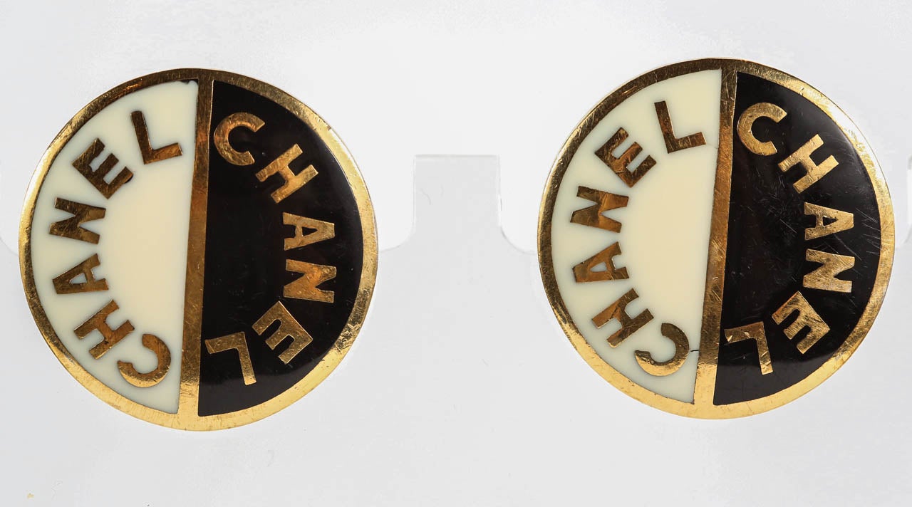 A statement-making pair of large-scale gilt metal cufflinks by Chanel with black and cream enamel. These were designed to be ear clips and at some point during their lifetime were converted to cufflinks. The backside of each bears the 