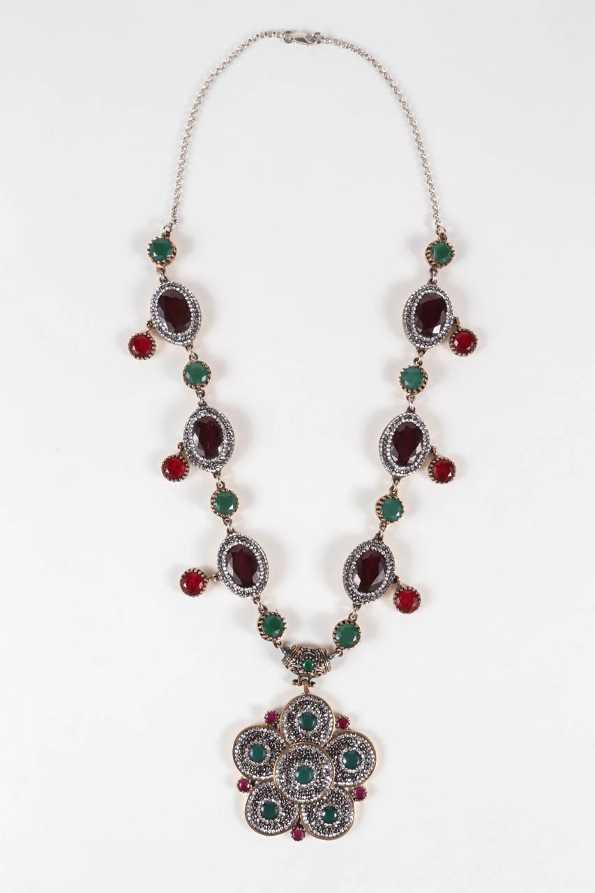 A 20th century homage to Mogul jewelry, this beautiful gold washed sterling silver necklace & earring set is set with sparking rhinestones and faceted paste stones. Stamped 