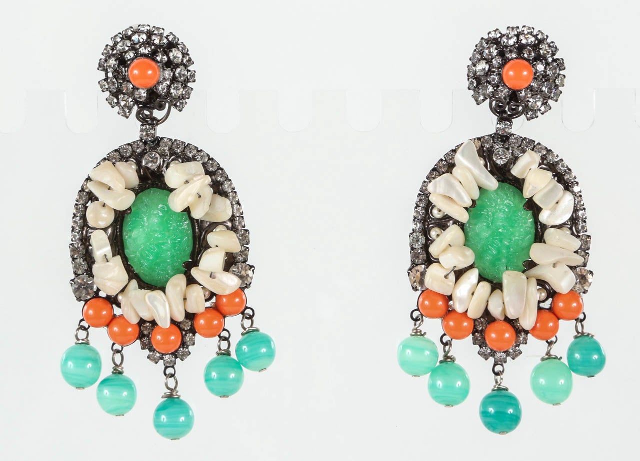 A dramatic pair of mother of pearl, rhinestone and faux jade & coral chandelier ear clips by noted costume jewelry designer Lawrence Vrba, who worked for Miriam Haskell before launching his own line.