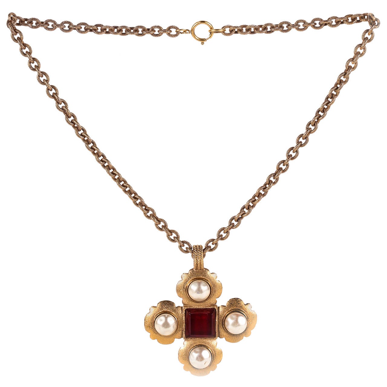 A statement making necklace by Chanel with a Maltese cross pendant set with an emerald cut piece of cranberry glass and dimpled glass pearls. The chain itself is beautifully detailed with a textured pattern (see Image 4). The length given below is