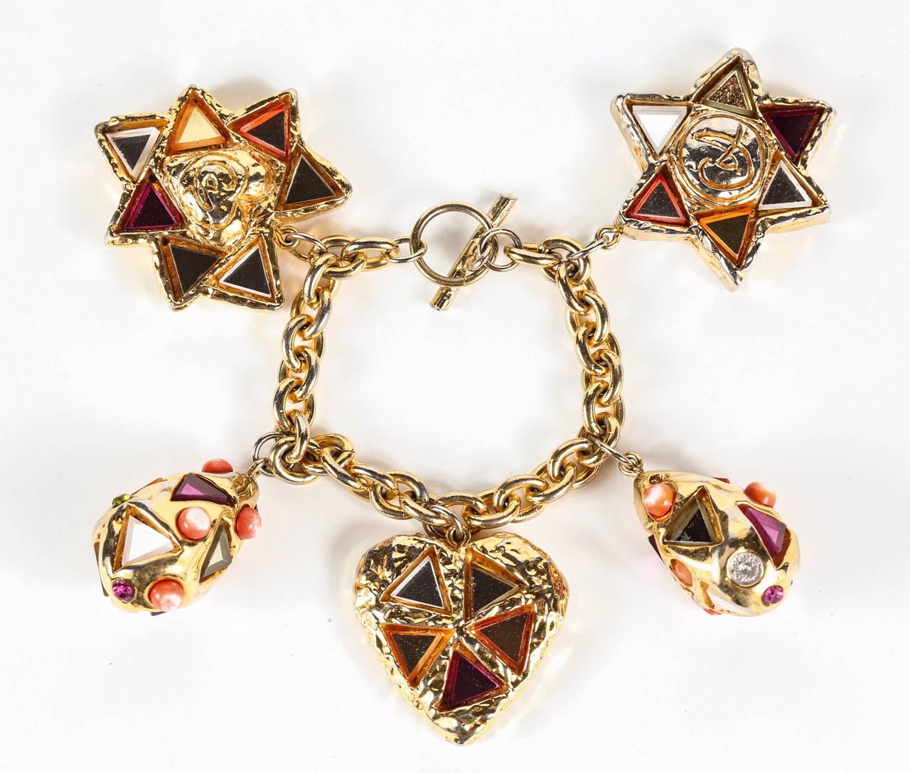 A fun pair of oversized heart ear clips, featuring colorful triangular mirror pieces inset in a textured gilt metal base that bears the CL logo on the front and a the 