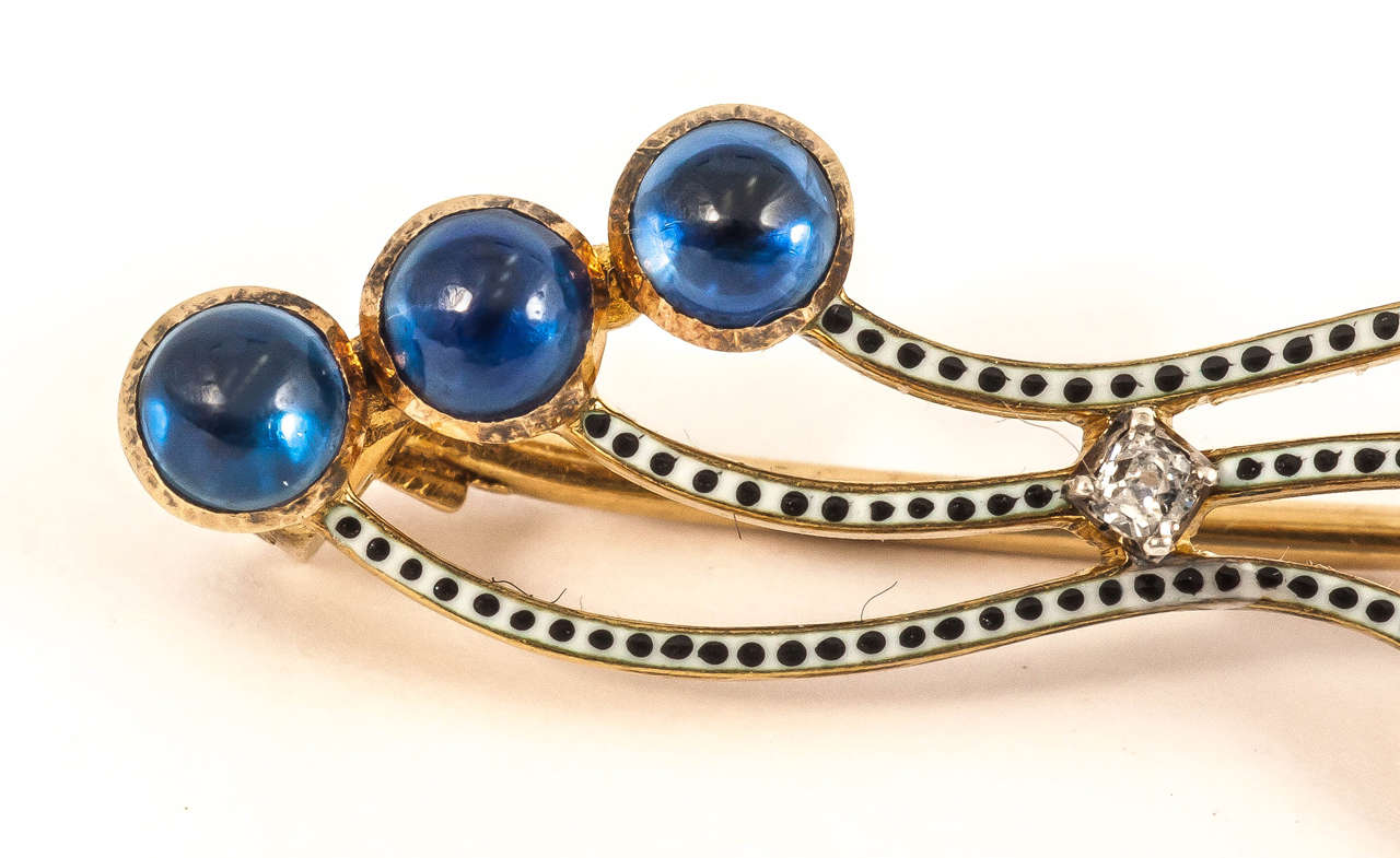 Gold mounted sapphire black and white enamel and single diamond brooch signed by Carlo Giuliano, circa 1890.