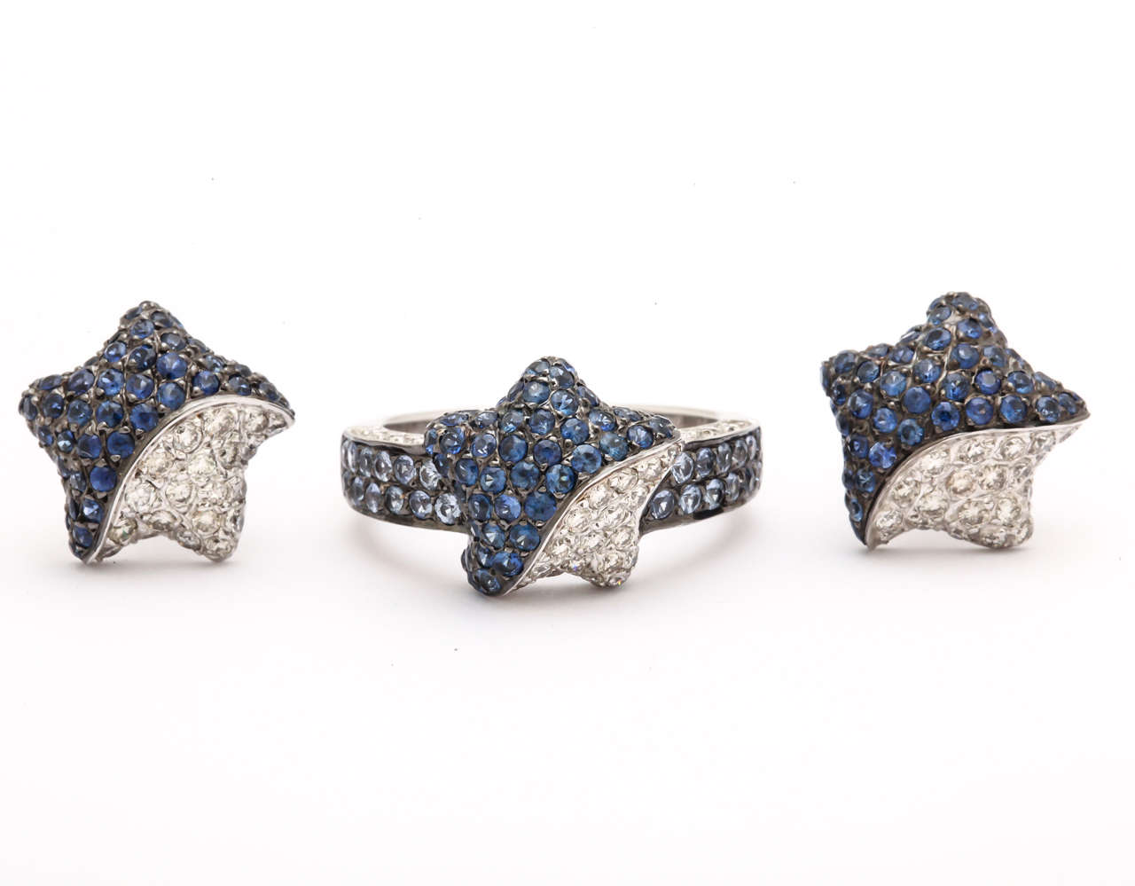 For the Star in your life. The ring is pave set in 18kt white gold with .55 ct white diamonds and 1.2 ct midnight blue sapphires. The sapphires and diamonds go down along the shank of the ring for increased elegance.

The star earrings are set