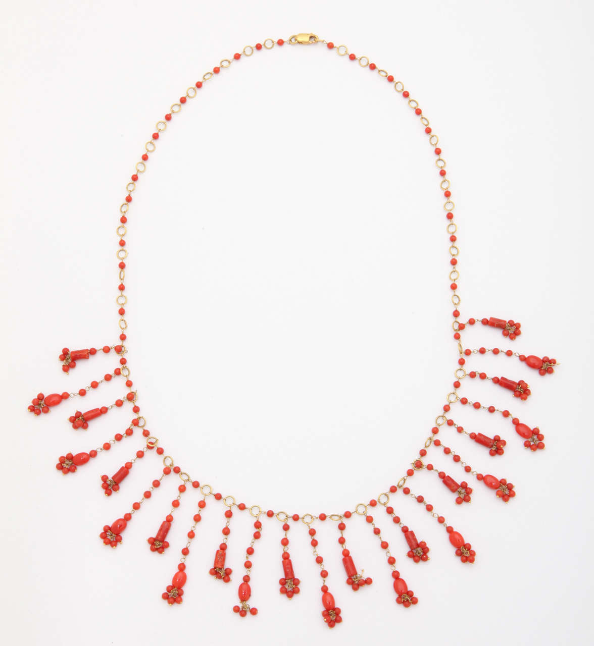 The bright red/orange coral beads are wrapped  with 18 kt gold wire. The total length is 18 1/2 in. This necklace is light and delicate, great for the summer.
Earrings can be made to match.