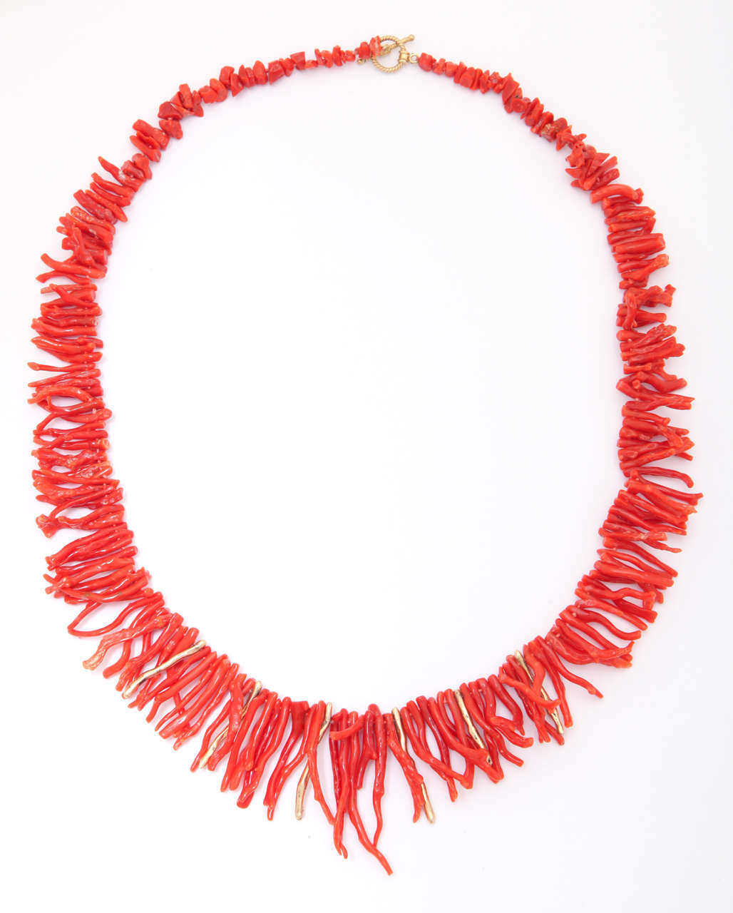 Classical and now rare red branch coral from the Mediterranean Sea. The coral graduates from small to large, the larges branches are 1 1/4 to 1 1/2 in. long. The total length of the necklace is 21 1/2 in. Interspersed in the center among the long