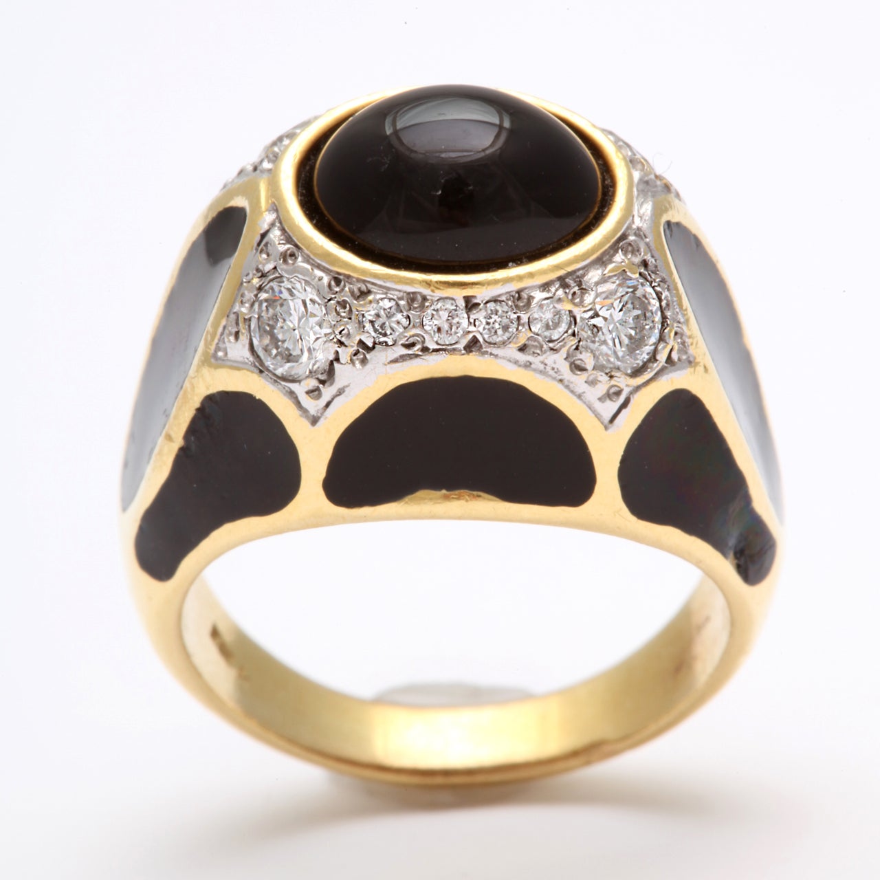 Highly stylized Black enamel Ring set with  a central Cabochon Onynx & set around with Full cut clean & white Diamonds in Platinum. Shoulders enameled with a series of stylized Black Enamel Panels. 18kt Yellow Gold & Platinum. Size 7 1/2.