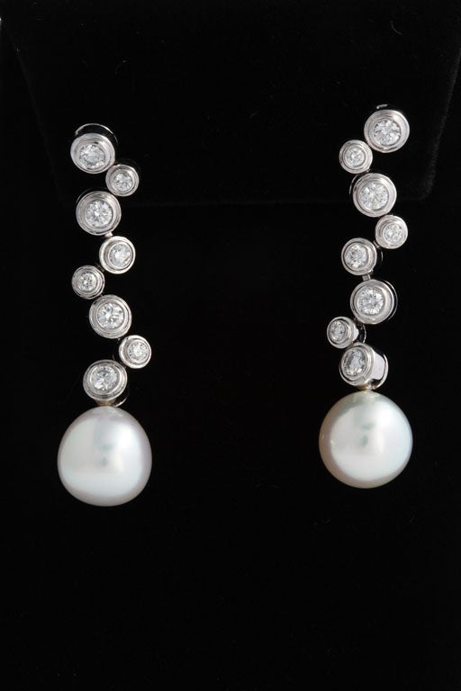 In the Tiffany Bubble Style, these earrings are a true classic.  Each earring has 8 bezel set diamonds and a detachable South Sea Pearl.  The earrings can be worn either way by unscrewing the pearl.