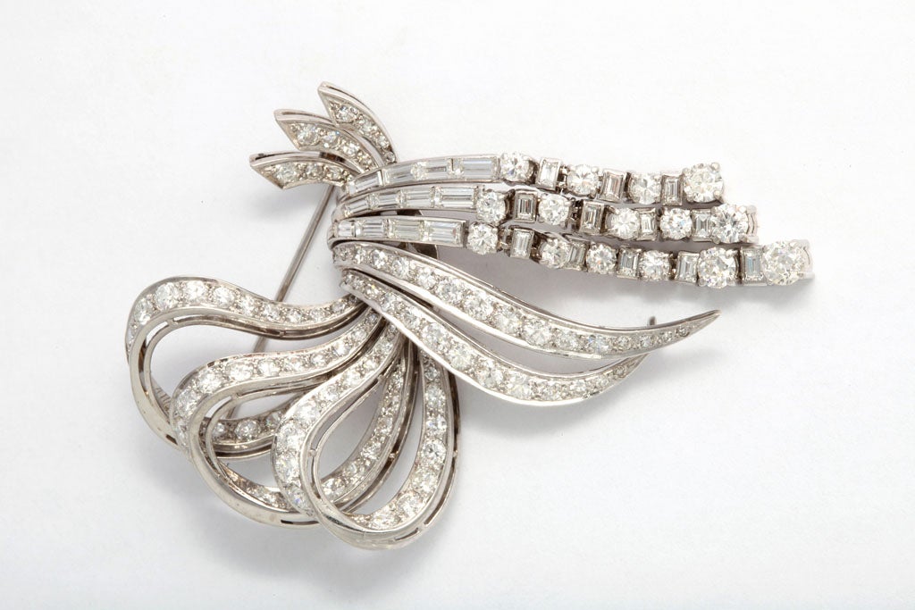 Wonderful diamond bow brooch with 9 carats of diamonds set in a platinum articulated mounting.  The bottom three rows of round diamonds dangle.  3" long by 2"