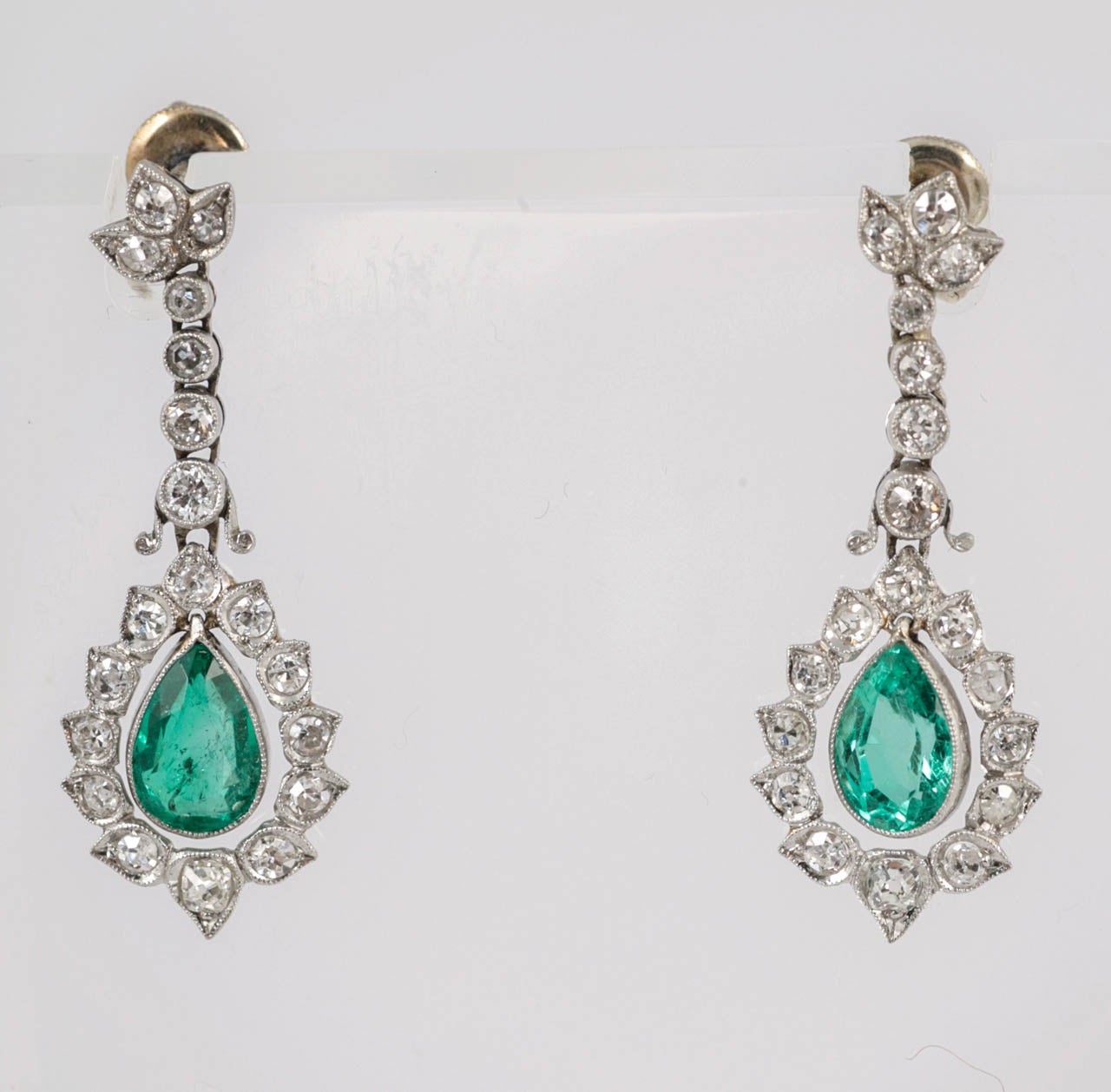 Columbian Emeralds surrounded by Diamonds set in Platinum.