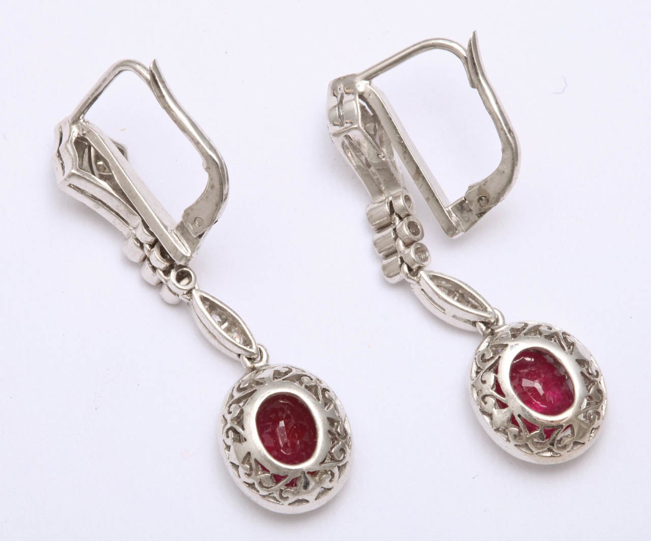 18kt  crown  setting ruby drop earrings, embellished with numerous old mine cut diamonds weighing approximately 1.50 carats and ruby weighing .50 carat each.