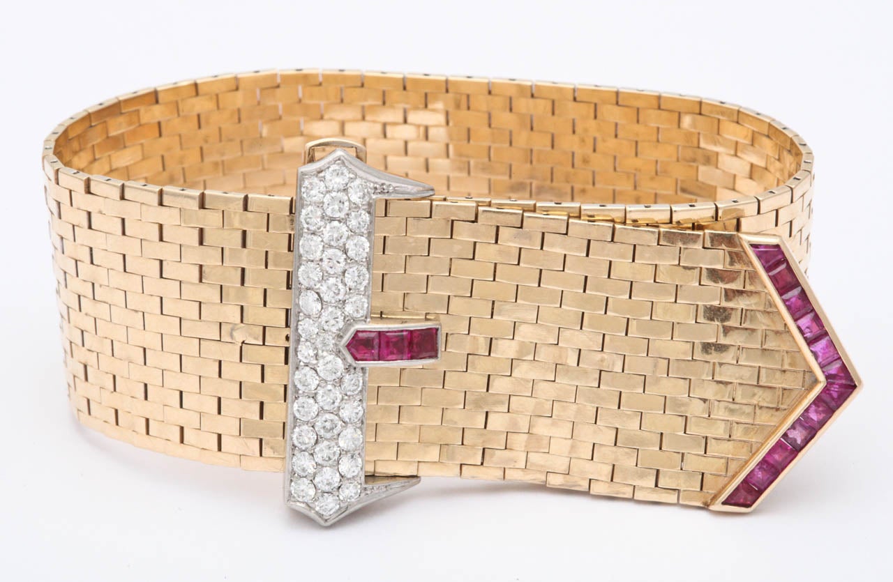 14kt yellow gold belt buckle strap bracelet, embellished with custom cut, calibre cut burmese rubies and high quality full cut diamonds. Designed by Tiffany & Co., with handmade brick mesh. Diamonds set in platinum. Flexible mesh may be adjusted to