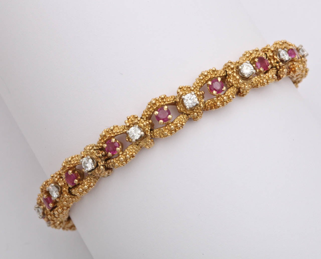 18kt Yellow Gold open link flexible Burmese ruby and high quality bracelet. Signed Tiffany & Co. With very high quality full cut diamonds. Circa 1950s.