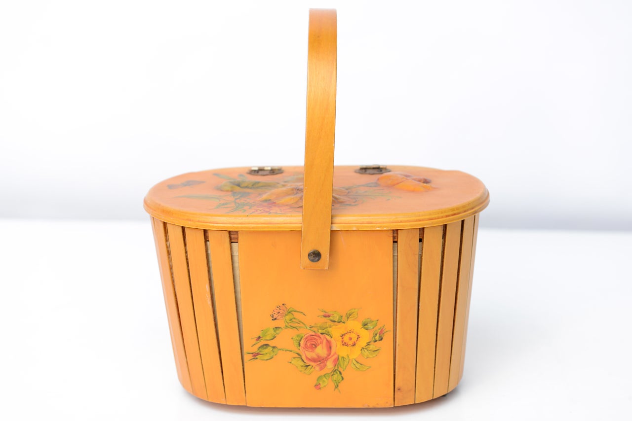 Delightful hand basket with applied flower decoration. Movable handle slides out of the way to open. Under lid applied with birds and nest decoration.