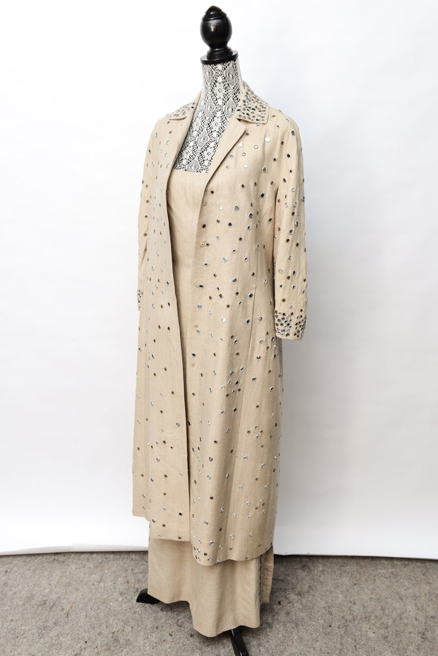 Stylish with small mirrored accents that accessorize nicely with sterling jewelry. There is full length coat and full length dress to match. Accents down side of dress and all over coat. 3/4 sleeve. Open squared plunging back.