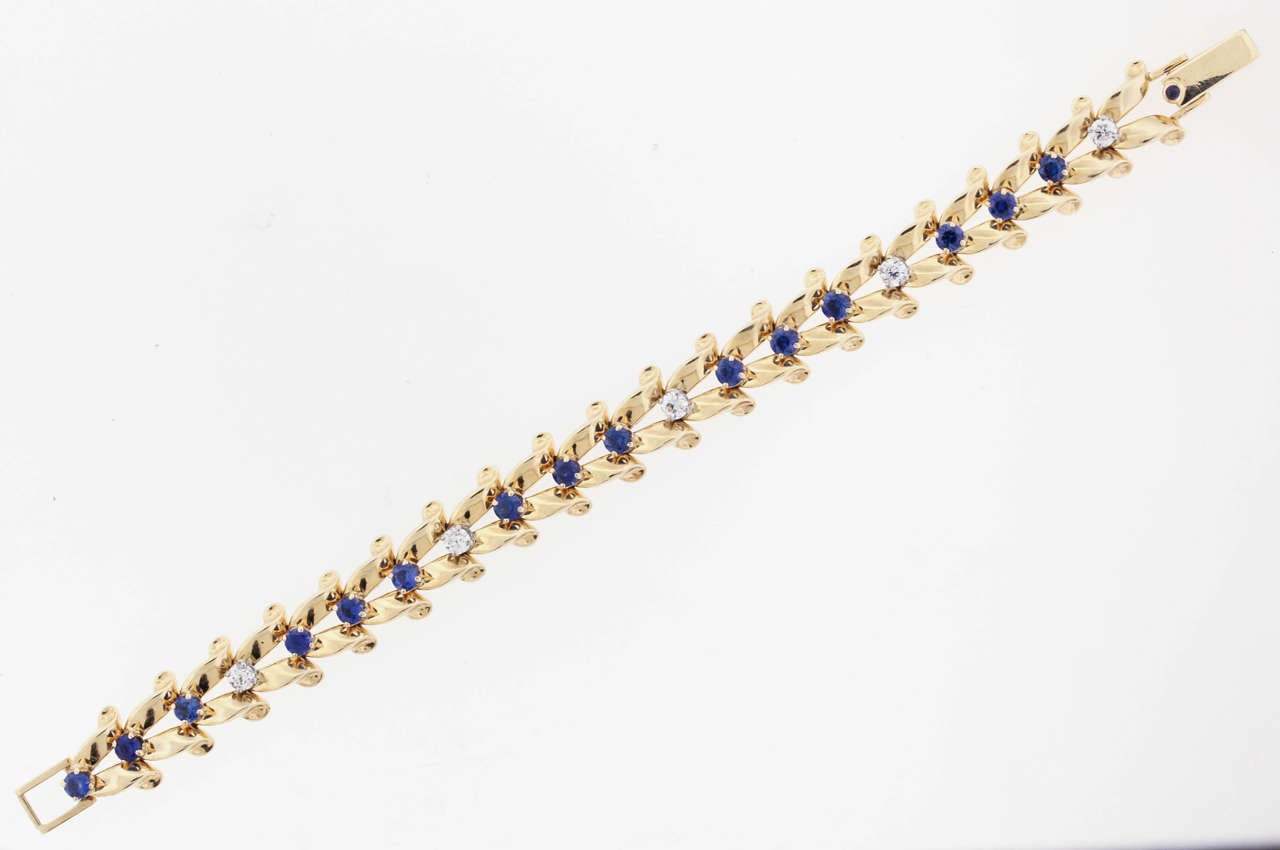 Sapphire and diamond ribbon-link bracelet by famed New York jeweler Raymond Yard, circa 1940's, is 14K gold, the split-ribbon links alternately set with round sapphires and diamonds, the bracelet measures 3/8