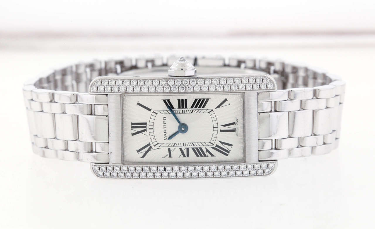 18K white gold Cartier Tank Américaine, Ref. 2489, made in the 1990's, is a water-resistant, rectangular-curved, 18K white gold and factory diamond women's quartz wristwatch with an 18K white gold Cartier bracelet.The 19mm x 35mm case has a case