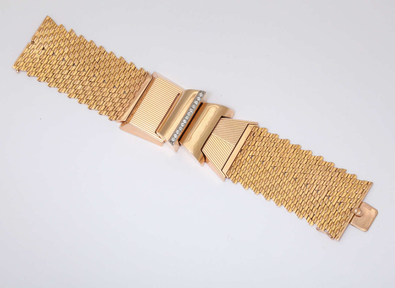Of architectural design on a flexible band decorated with a line of brilliant-cut diamonds.