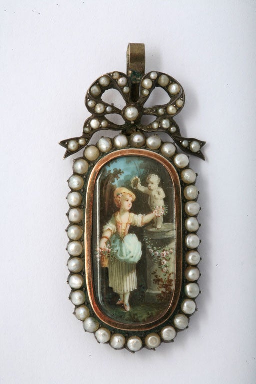 French painted Enamel Pendant depicting a Shepherdess paying homage to a statue of a Cherub.   19th Century.