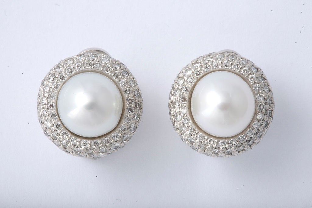 Lustrous 10.5mm Cultured Pearl Earrings , clip on, set in 18kt White Gold & pave set with full cut Diamonds.  The Diamonds are clean & white & measure over 4 cts total.