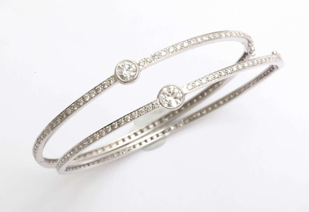 18K white gold bangles featuring .075 carats in old miners, totaling 1.50 carats.