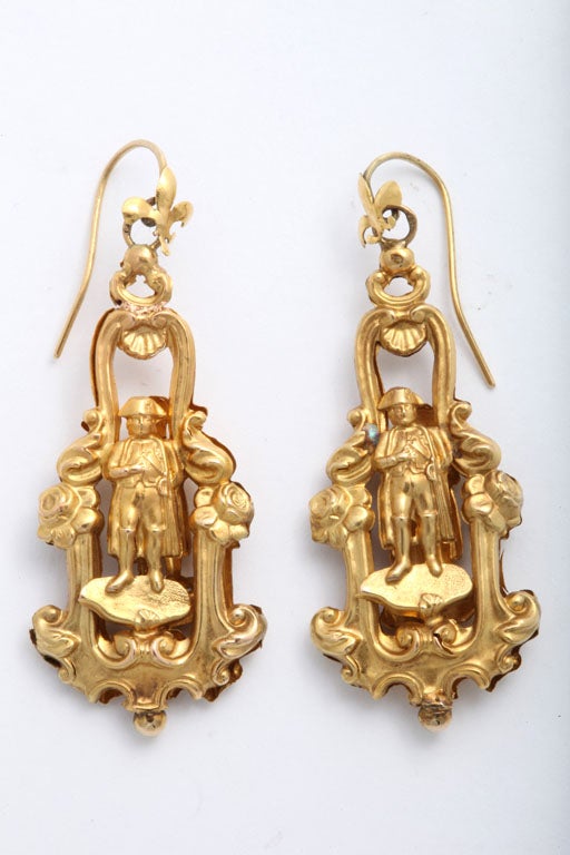 This unusual pair of Georgian earrings of 18kt gold have French hallmarks.  They are, as are most Georgian earrings, extremely light on the ear. Fleur de Lis ear wires hold two gold wafers pressed together. The photo shows their secret and their