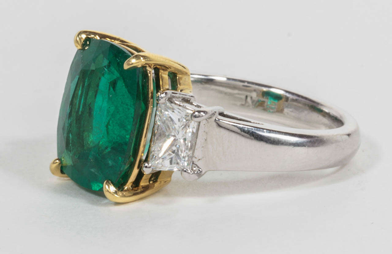 A beautiful Emerald.

Fine color and clarity emerald of 5.04 carats set with a carat of trapezoid cut diamonds. This ring was custom made in New York. The three stones are set in platinum and 18k yellow gold.