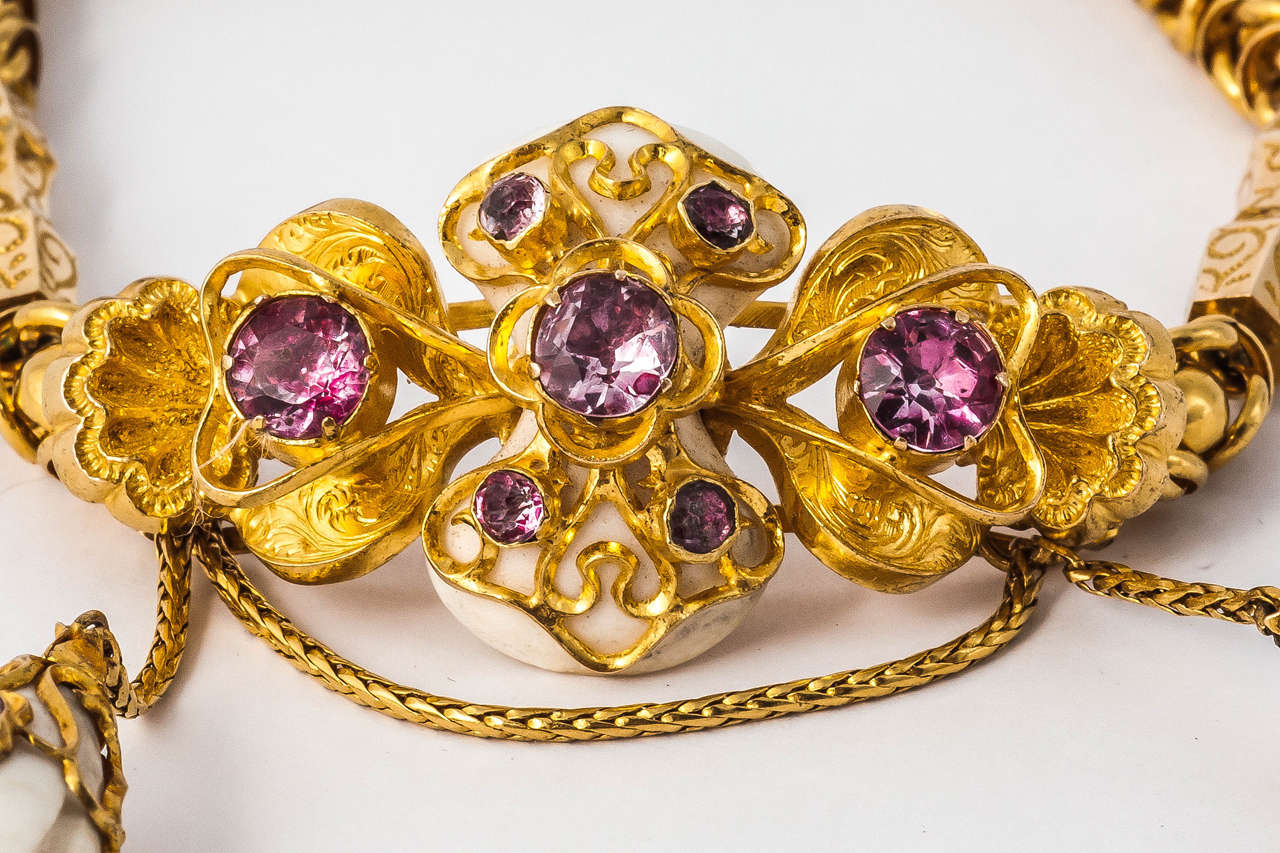 Regency Gold Bracelet with 2 drops of  carved shell.  Set with pink Topaz and has a small secret locket in the back. In original fitted case.
