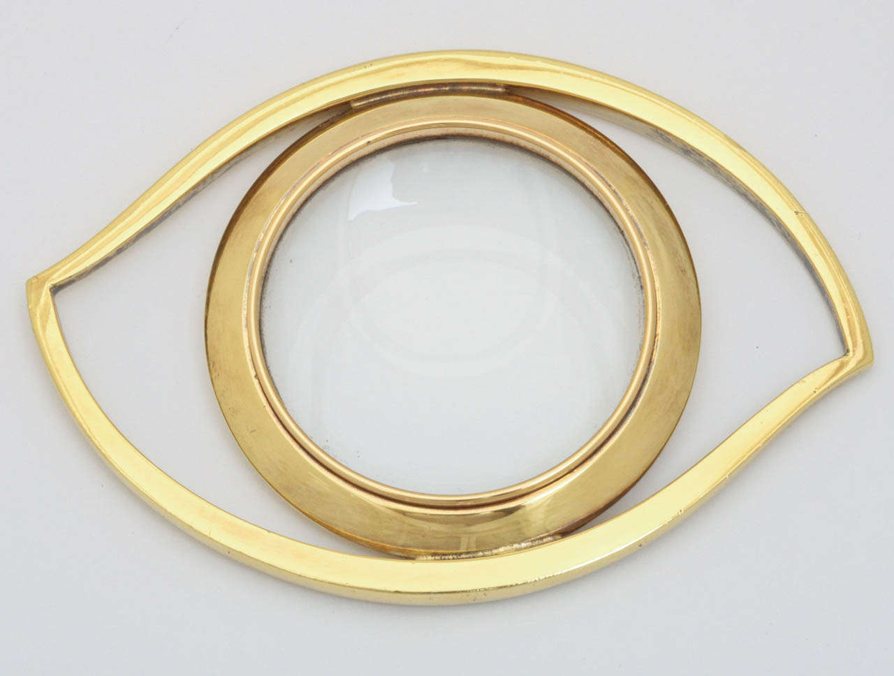 A gold plated magnifying glass in the shape of an eye by Hermes Paris. Marked Hermes Paris. Nice older example in the original Hermes box. Excellent condition.