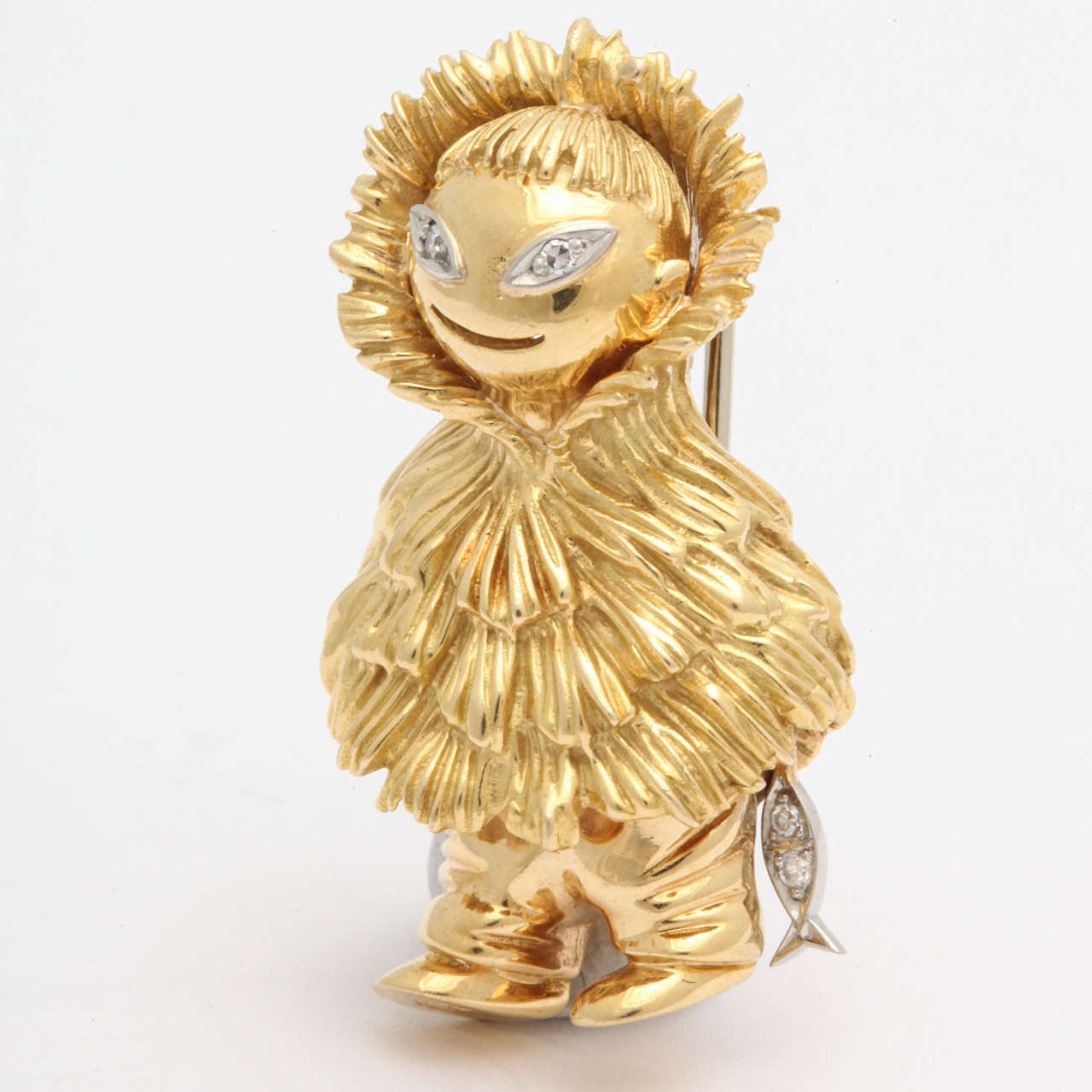 18KT yellow gold whimsical and figural Eskimo brooch embellished with diamond eyes and holding a fish with diamonds.

Beautiful textured gold workmanship for his hat & attire.
American made circa 1950s.