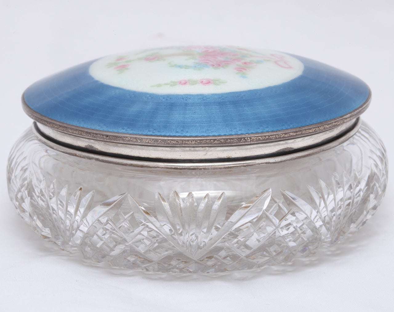Art Deco Pink Blue And White Enamel Crystal Dresser Jar made of hand cut crystal and hand applied guilloche enamel with gorgeous flower basket design in center of jar lid